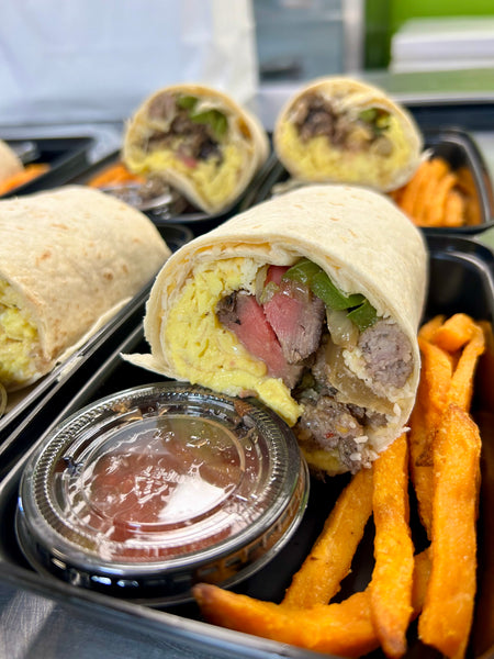 Steak Scramble Breakfast Burrito with scrambled eggs, steak, and peppers served with sweet potato fries and sauce cup